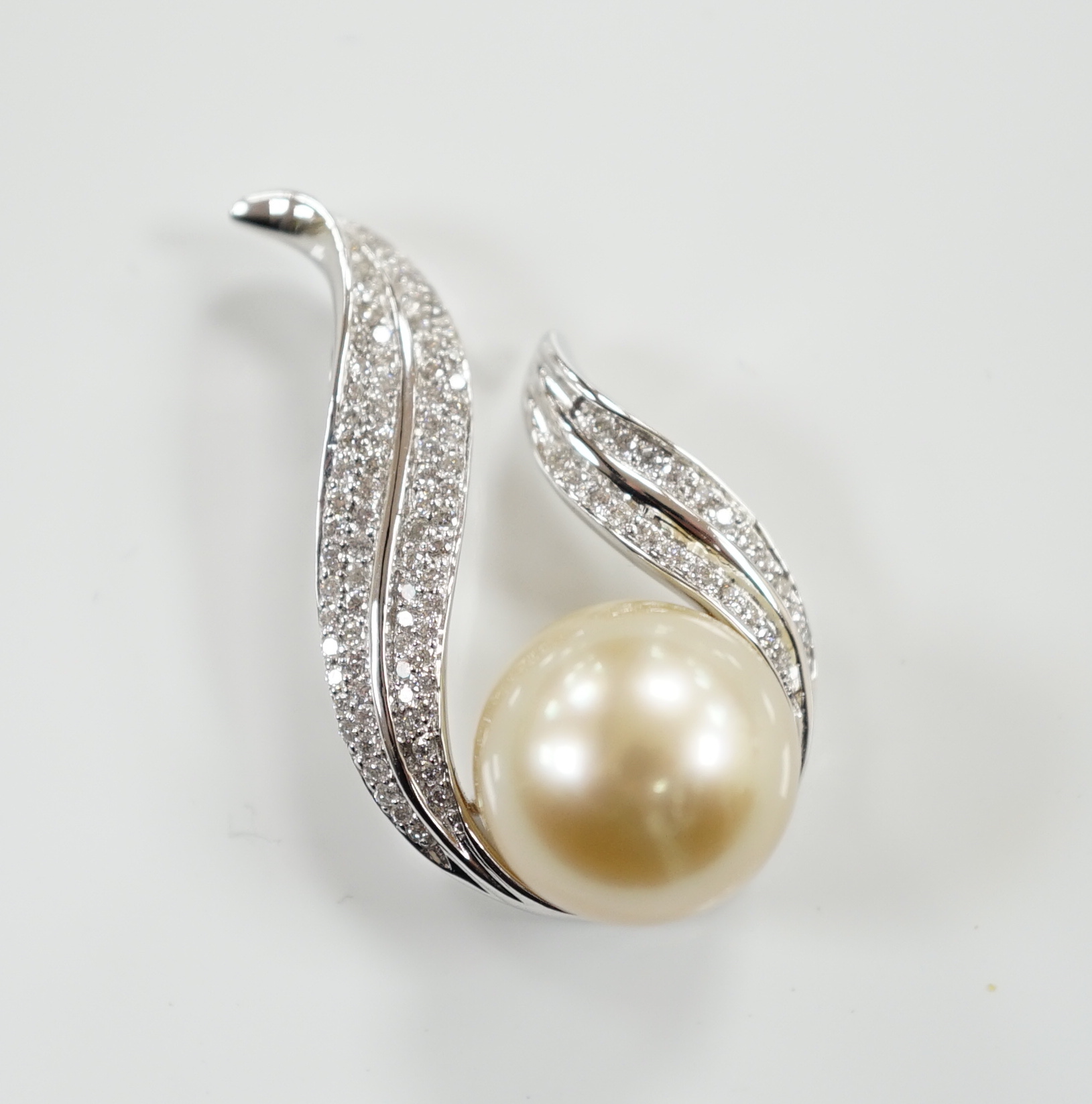 A modern 18ct white gold, single stone South Sea cultured pearl and diamond chip cluster set pendant, 32mm, gross weight 7.1 grams.